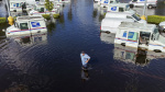 Residents slog through flooded streets clear debris after Hurricane Milton tore through Florida  The Associated Press